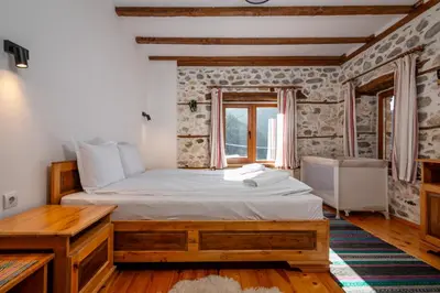 a bedroom with a large bed and a window at Villa Martina in Smilyan