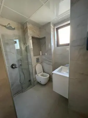 a bathroom with a toilet and a shower and a sink at Apartment Park View in Sandanski