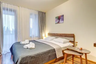 a bedroom with a bed with two towels on it at Cozy Studio in Grand Resort Pamporovo by Flat Manаger in Pamporovo