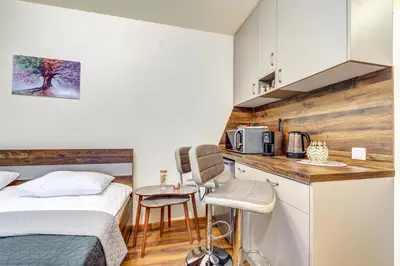 a small bedroom with a bed and a kitchen at Cozy Studio in Grand Resort Pamporovo by Flat Manаger in Pamporovo