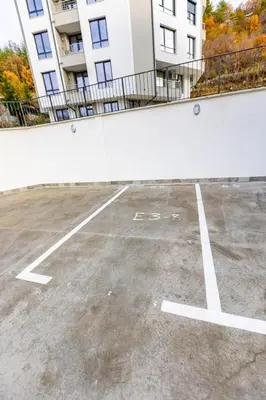 an empty parking lot in front of a building at Apartment Golden Park in Sandanski