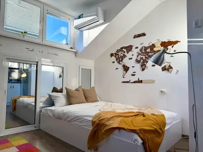 a bedroom with a bed and a world map on the wall at Comfy Studio by Cosher in Sofia