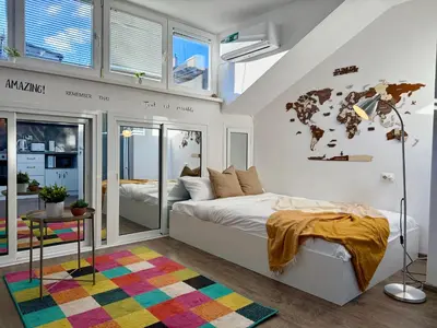 a bedroom with a bed and a world map on the wall at Comfy Studio by Cosher in Sofia