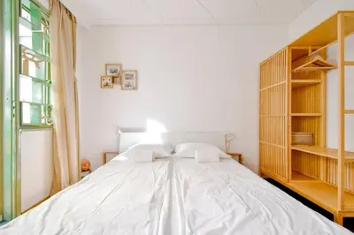 a bedroom with a large white bed and a window at Central Duplex Wi-Fi, Kitchen, Netflix, Heating in Sofia