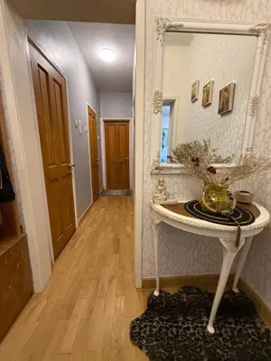 a hallway with a mirror and a table with a mirror at Апартамент ГТ in Plovdiv
