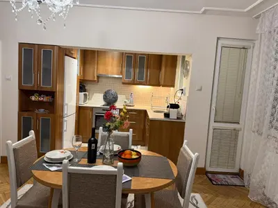 a kitchen and dining room with a table and chairs at Апартамент ГТ in Plovdiv