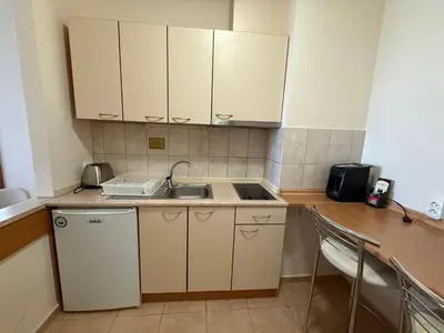 a small kitchen with white cabinets and a sink at Apartment for 6 in Flora main building - prime location! in Borovets