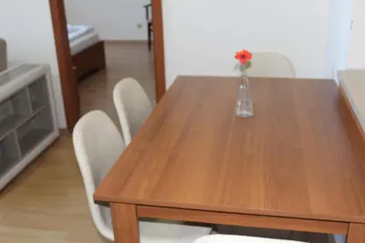 a wooden table with a vase of flowers on it at Apartment for 6 in Flora main building - prime location! in Borovets