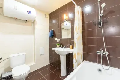 a bathroom with a toilet and a sink and a shower at Liftside Alpine Suite in Bansko