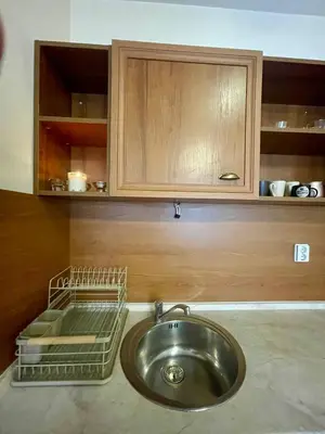 a kitchen with a sink and a wooden cabinet at Mountain view 1-bedroom apartment few steps from ski piste and Gondola lift in Bansko