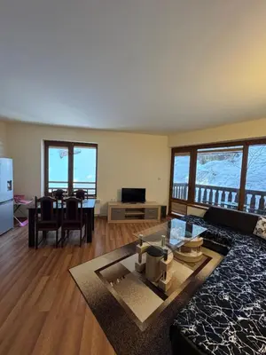 a living room with a couch and a table at Mimsi Apartment in Pamporovo