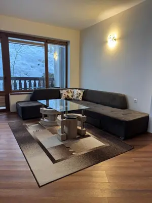 a living room with a couch and a table at Mimsi Apartment in Pamporovo