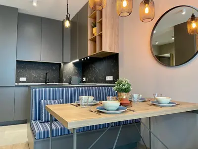 a kitchen with a table and a mirror at Apartment with Free Underground Parking by COSHER in Sofia