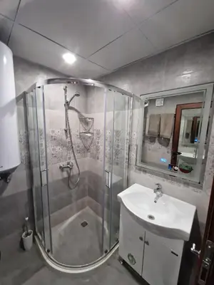 a bathroom with a shower and a sink at Villa Popovi in Simitli