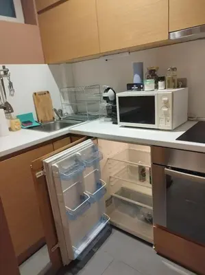 a kitchen with an open refrigerator and a microwave at The Cathedral in Sofia