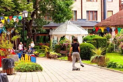 a young boy riding a skateboard in a garden at Rich House Velingrad in Velingrad