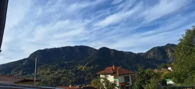 a view of a mountain range with a house at Студио Вили in Smolyan