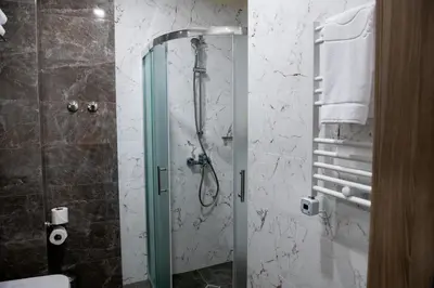 a shower with a glass door in a bathroom at BG Hotel in Sofia