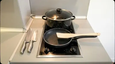 a pair of pots and pans on a stove at Mountain Paradise 2 - Cosy 2 Bed Mountain View Apartment - Washer in Bansko