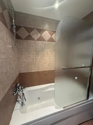 a bathroom with a bath tub with a shower at Prime location one bed apartment with hydro bath in Royal Plaza in Borovets