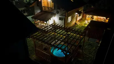 an overhead view of a house with a swimming pool at night at Къщи за гости 'Веринско' in Verinsko