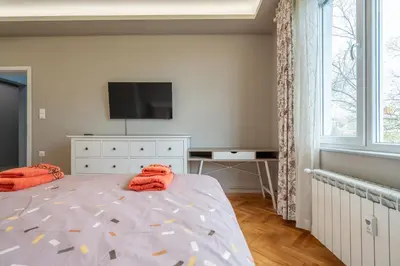 a bedroom with a bed with orange towels on it at Green Haven in Sofia
