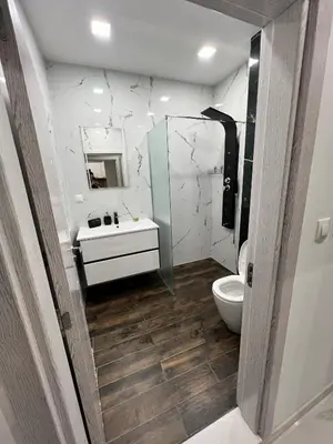a bathroom with a toilet and a sink and a mirror at Royalton Résidence in Plovdiv