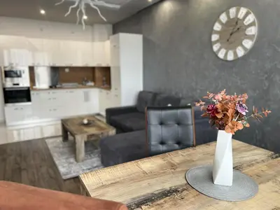 a vase of flowers on a table in a living room at Royalton Résidence in Plovdiv