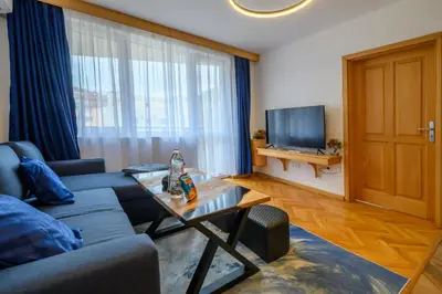 a living room with a couch and a table at Cozy 2BDR & Peaceful Location & Free Street Parking in Blagoevgrad