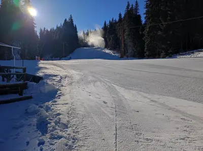 a snow covered road with footprints in the snow at STRIM Apartment 406 Stream Resort, Pamporovo in Pamporovo
