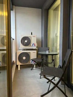 a room with a table and chairs and a microwave at Delux 1 - Plovdiv Луксозен апартамент с паркинг in Plovdiv