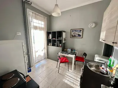 a kitchen with a sink and a table in a room at Downtown Serenity Apartment in Sofia