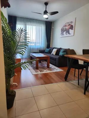 a living room with a couch and a table at Elegant Apartment Ski Access Premium Spa in Bansko