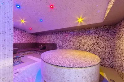 a bathroom with a purple ceiling and a tub and a stool at Elegant Apartment Ski Access Premium Spa in Bansko
