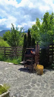 a barbecue grill sitting next to a fence at Cosy 2-bedroom apartment near the ski road Bansko in Bansko