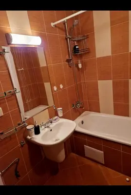 a bathroom with a sink and a toilet and a tub at Pirin Golf Hotel & Spa in Razlog
