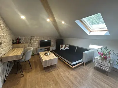 a room with a bed and a table and a window at Lambrina Boutique rooms in Plovdiv