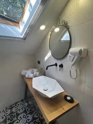 a bathroom with a sink and a mirror at Lambrina Boutique rooms in Plovdiv