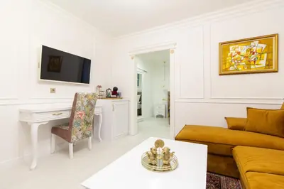 a living room with a couch and a table at Lambrina Boutique rooms in Plovdiv