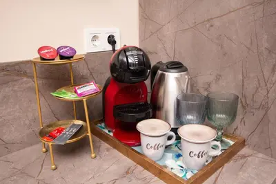 a shelf with a coffee maker and cups on it at Lambrina Boutique rooms in Plovdiv