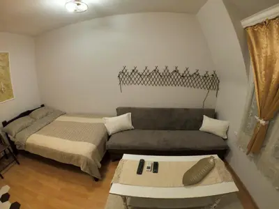 a living room with a couch and a bed at Mini Quiet Central Studio in Pazardzhik