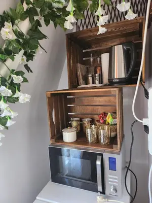 a microwave with a shelf on top of it at Mini Quiet Central Studio in Pazardzhik