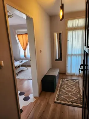 a hallway with a room with a bed and a mirror at Mini Quiet Central Studio in Pazardzhik