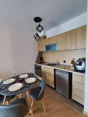a kitchen with a table and chairs in a kitchen at Aspen Resort Studio I306 in Razlog