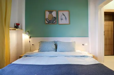 a bed in a bedroom with two pictures on the wall at Classy Residential 1BDRM Flat With View and Elevator in Sofia