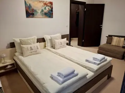 a bedroom with a large bed with towels on it at Snow Forest in Borovets