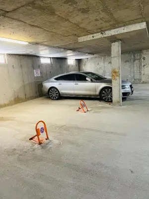 a white car parked in a parking garage at Snow Forest in Borovets