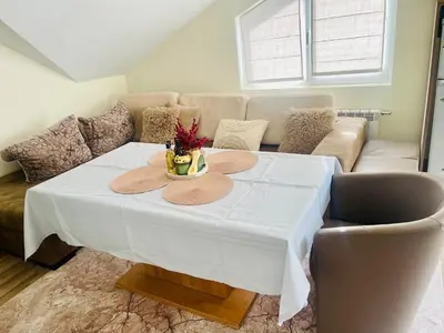 a living room with a table and a couch at Snow Forest in Borovets