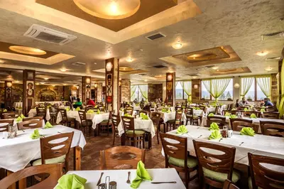 a dining room with white tables and chairs at SPA Hotel Elbrus in Velingrad
