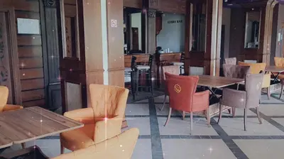 a restaurant with wooden tables and chairs and tables and chairs at Apartment Wintermärchen Bansko in Bansko